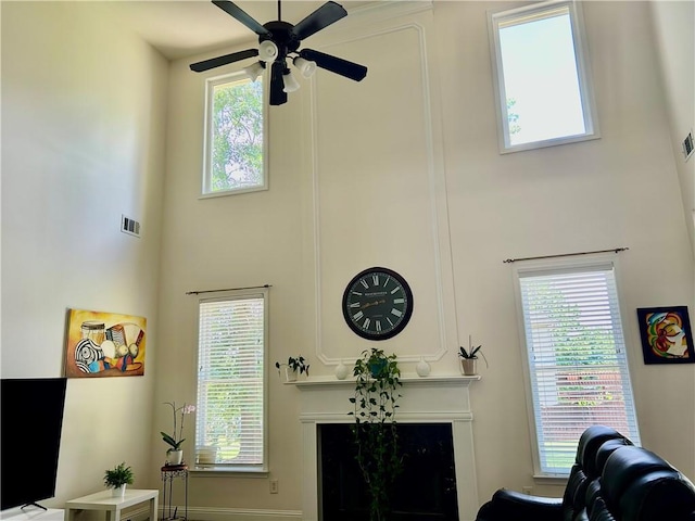 1055 Havenstone Walk, Lawrenceville, GA 30045 - living room featuring a towering ceiling, a fireplace, and a ceiling fan