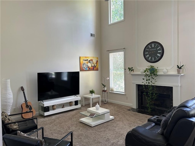 1055 Havenstone Walk, Lawrenceville, GA 30045 - carpeted living room featuring a high end fireplace and a high ceiling