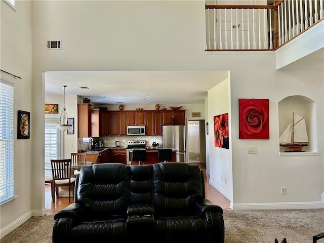 1055 Havenstone Walk, Lawrenceville, GA 30045 - living area with a towering ceiling and light colored carpet