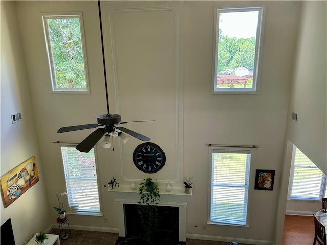 1055 Havenstone Walk, Lawrenceville, GA 30045 - living room featuring ceiling fan, a high ceiling, and a high end fireplace