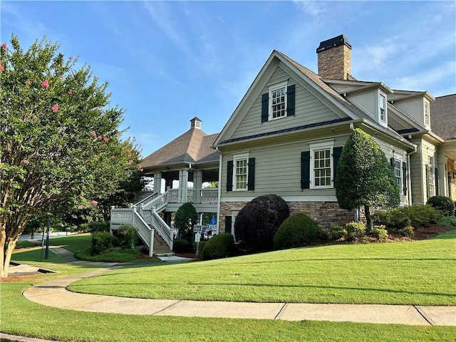 1055 Havenstone Walk, Lawrenceville, GA 30045 - view of front of home featuring a front yard, stone siding, a chimney, and stairway