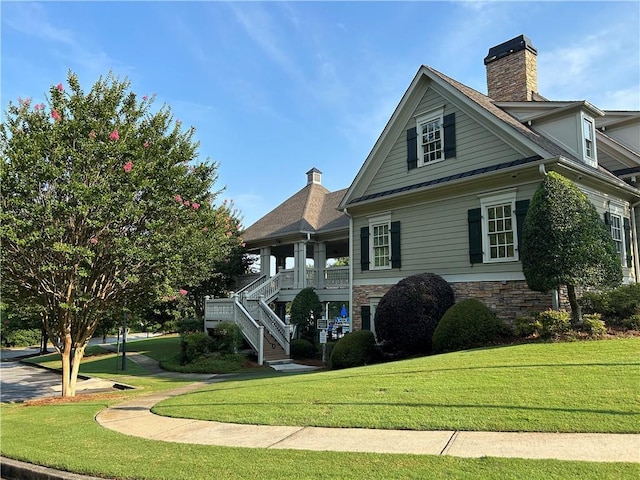 1055 Havenstone Walk, Lawrenceville, GA 30045 - view of front of property featuring a front lawn, stone siding, a chimney, and stairs