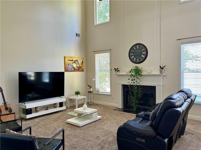 1055 Havenstone Walk, Lawrenceville, GA 30045 - living room featuring a high ceiling, carpet floors, healthy amount of natural light, and a high end fireplace