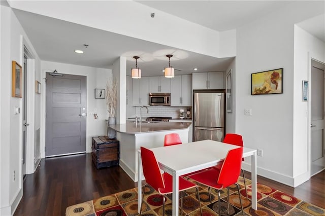 dining room featuring dark hardwood / wood-style flooring and sink