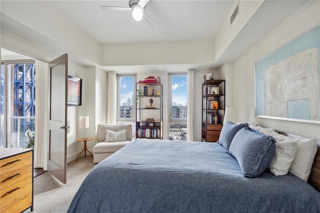 bedroom featuring ceiling fan and light carpet