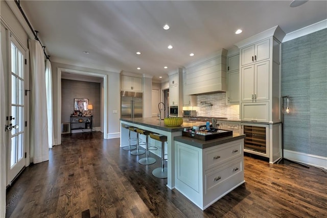 201 Dovecrest Dr, Atlanta, GA 30305 - kitchen featuring dark countertops, wine cooler, stainless steel built in refrigerator, baseboards, and recessed lighting