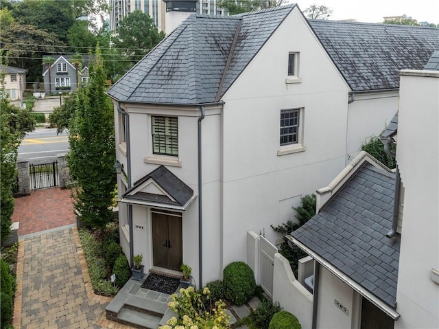 201 Dovecrest Dr, Atlanta, GA 30305 - view of front of house featuring stucco siding, a high end roof, and a gate