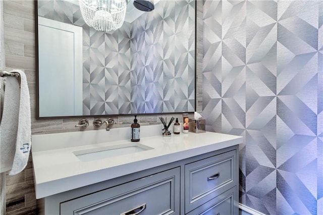 201 Dovecrest Dr, Atlanta, GA 30305 - bathroom featuring vanity, tile walls, and a chandelier