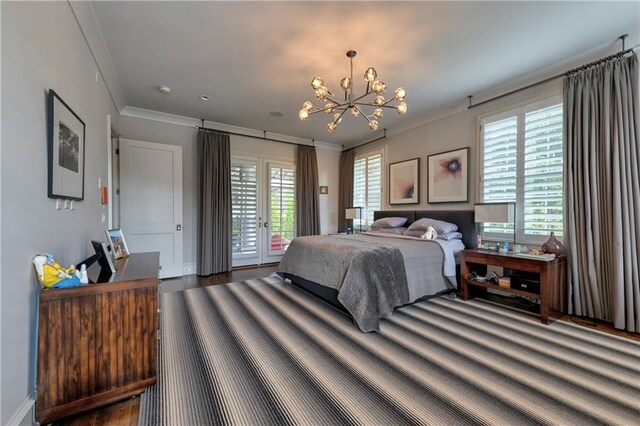 201 Dovecrest Dr, Atlanta, GA 30305 - bedroom featuring access to exterior, a chandelier, ornamental molding, wood finished floors, and french doors