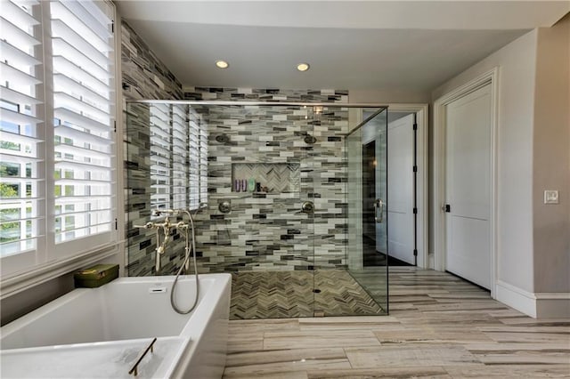 201 Dovecrest Dr, Atlanta, GA 30305 - bathroom featuring a bath, recessed lighting, a shower stall, and wood finished floors