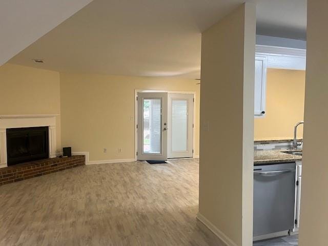 5950 Wintergreen Rd, Norcross, GA 30093 - unfurnished living room with a sink, wood finished floors, baseboards, and a fireplace