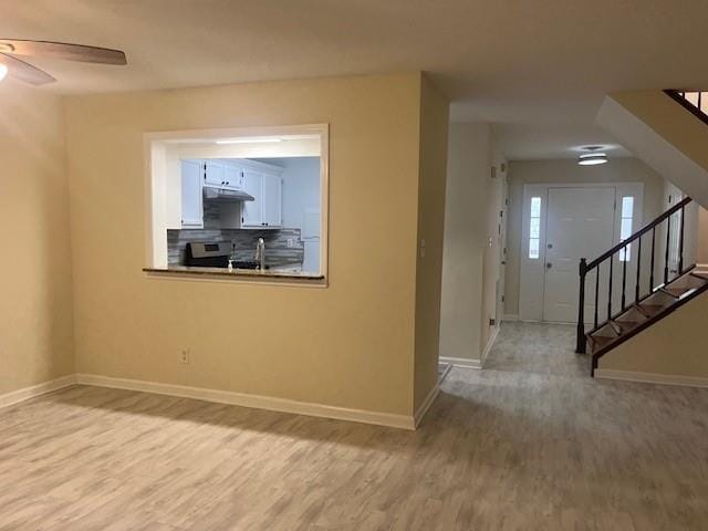 5950 Wintergreen Rd, Norcross, GA 30093 - empty room featuring baseboards, ceiling fan, stairway, and wood finished floors