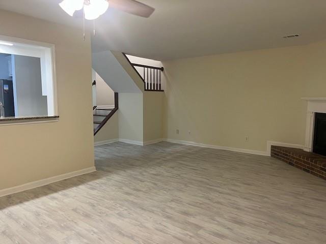 5950 Wintergreen Rd, Norcross, GA 30093 - unfurnished living room with wood finished floors, ceiling fan, stairs, baseboards, and a fireplace