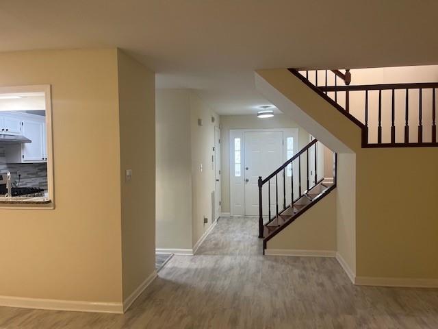 5950 Wintergreen Rd, Norcross, GA 30093 - entryway with wood finished floors, baseboards, and stairs