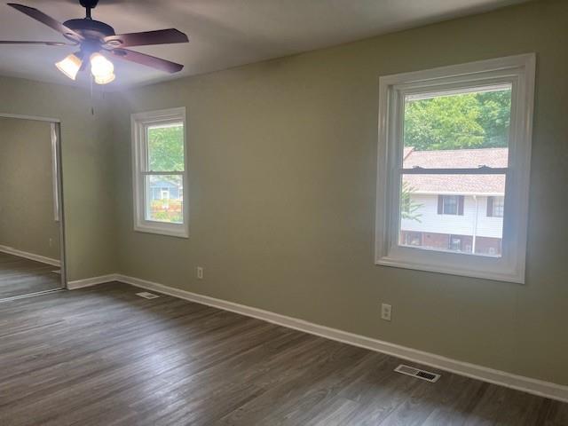 5950 Wintergreen Rd, Norcross, GA 30093 - spare room with baseboards, dark wood finished floors, and a ceiling fan