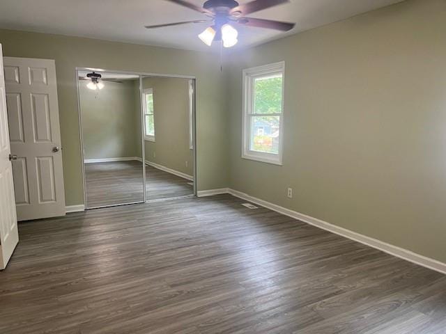 5950 Wintergreen Rd, Norcross, GA 30093 - unfurnished bedroom with multiple windows, a closet, and baseboards