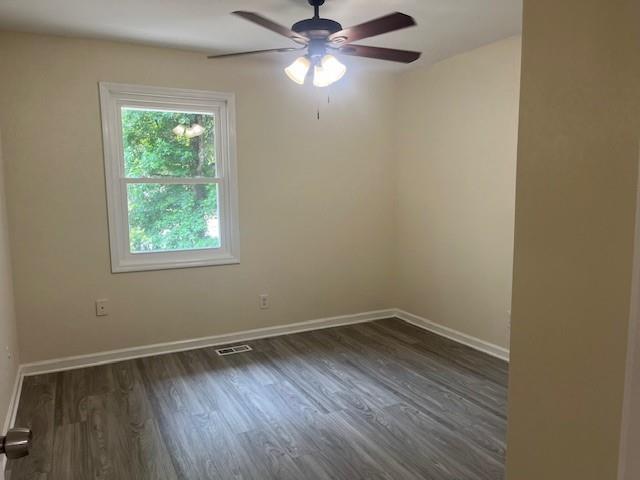 5950 Wintergreen Rd, Norcross, GA 30093 - spare room featuring ceiling fan, dark wood-style floors, and baseboards