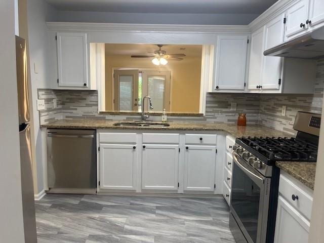 5950 Wintergreen Rd, Norcross, GA 30093 - kitchen with stainless steel appliances, a sink, white cabinetry, and stone countertops