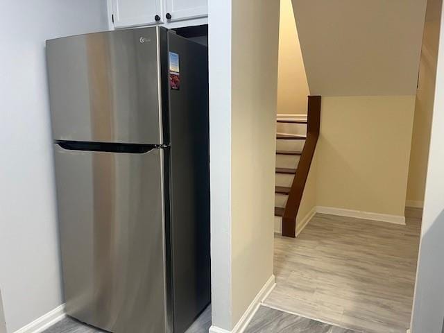 5950 Wintergreen Rd, Norcross, GA 30093 - kitchen with freestanding refrigerator, white cabinets, light wood-style flooring, and baseboards