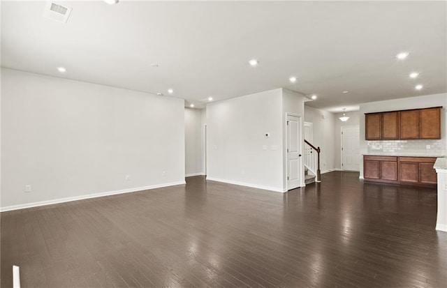 unfurnished living room with dark hardwood / wood-style flooring