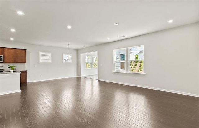 unfurnished living room featuring dark hardwood / wood-style flooring