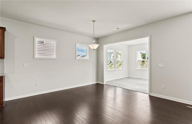 unfurnished dining area featuring dark hardwood / wood-style floors