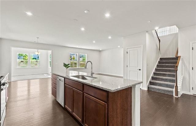 kitchen with pendant lighting, plenty of natural light, sink, a kitchen island with sink, and stainless steel dishwasher