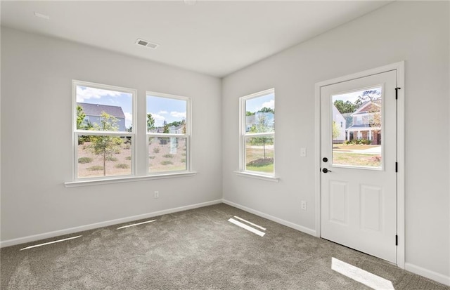 doorway to outside with carpet floors