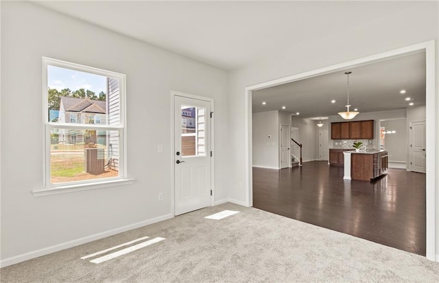 view of carpeted foyer entrance