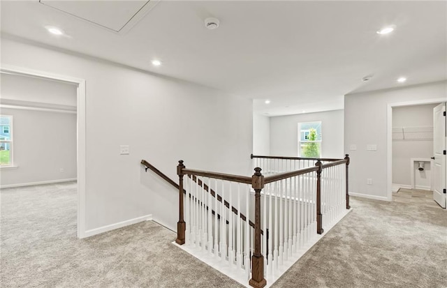 hall featuring light colored carpet