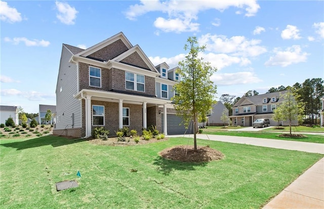 craftsman-style house with a garage, a front lawn, and covered porch