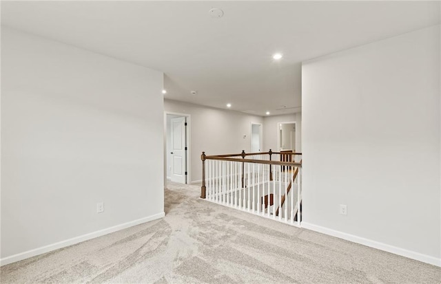 empty room featuring light colored carpet