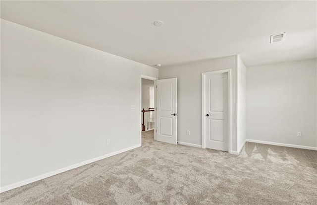 unfurnished bedroom featuring light carpet