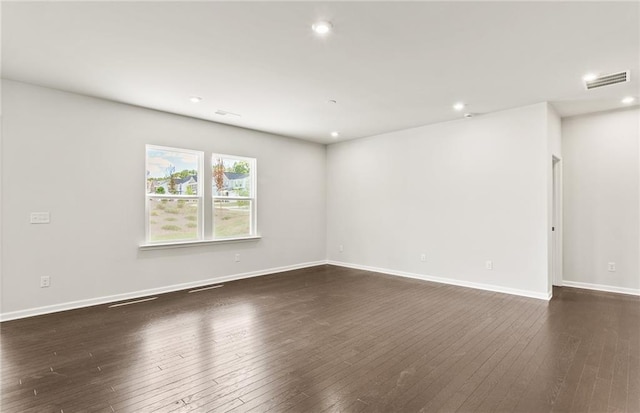 unfurnished room featuring dark hardwood / wood-style floors