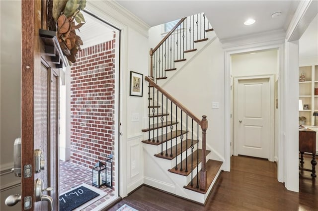 foyer featuring dark wood-style floors, stairway, ornamental molding, and recessed lighting