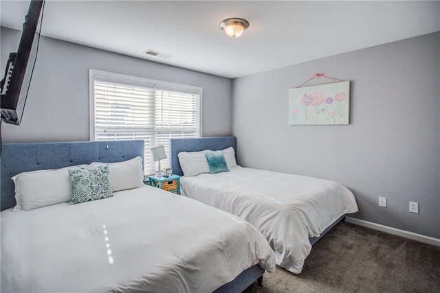 bedroom with dark colored carpet