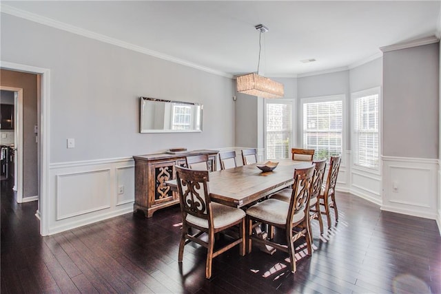 dining room with ornamental molding and dark hardwood / wood-style floors