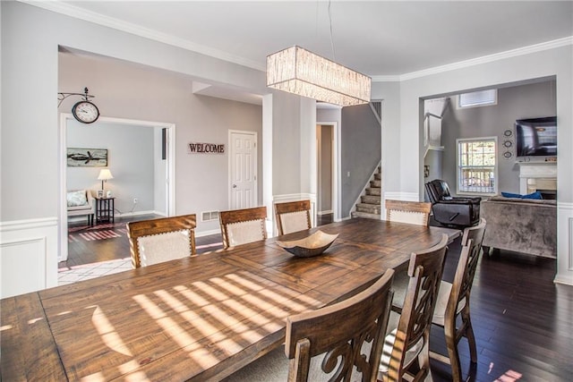 dining room featuring dark wood-type flooring and crown molding