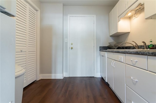 215 Piedmont Ave NE Unit 502, Atlanta, GA 30308 - kitchen with white cabinetry, dark wood-style flooring, dark countertops, and white dishwasher