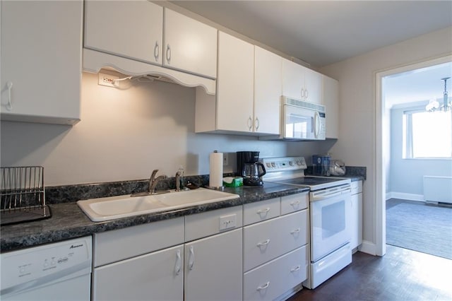 215 Piedmont Ave NE Unit 502, Atlanta, GA 30308 - kitchen featuring white appliances, white cabinetry, dark countertops, and dark wood-type flooring