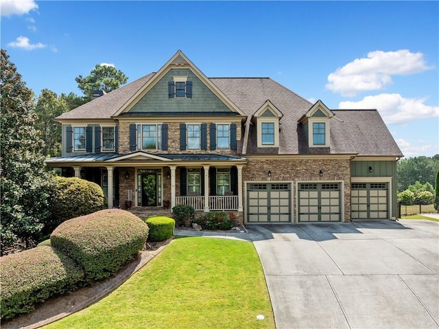 craftsman-style home with a porch, a garage, and a front lawn