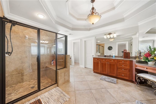 bathroom with tile patterned floors, ornamental molding, vanity, a raised ceiling, and a shower with shower door