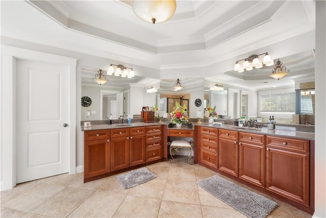 bathroom with a raised ceiling, tile patterned flooring, vanity, and ornamental molding