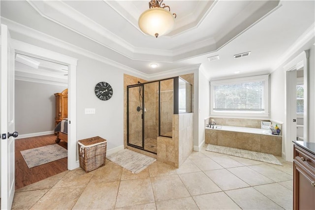 bathroom with plus walk in shower, tile patterned floors, a wealth of natural light, and ornamental molding