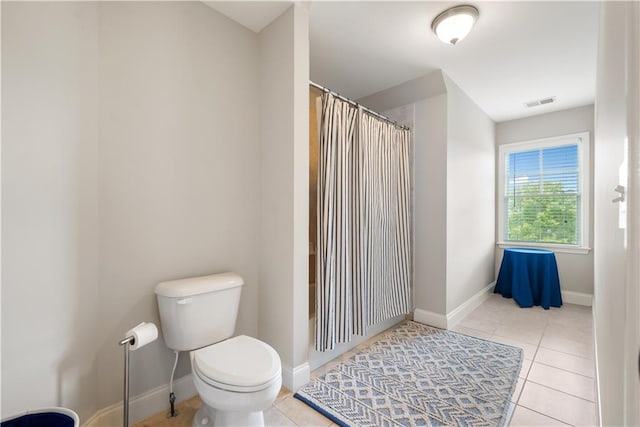 bathroom featuring tile patterned floors and toilet