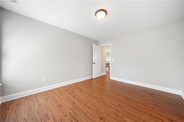 empty room with hardwood / wood-style floors