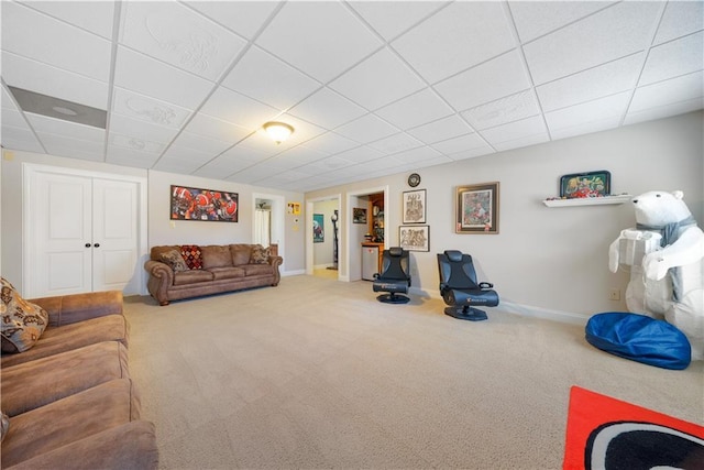 living room with carpet and a drop ceiling