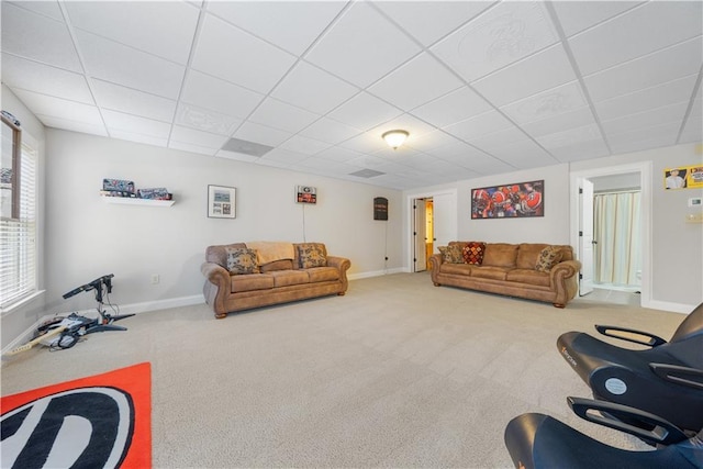 carpeted living room featuring a paneled ceiling