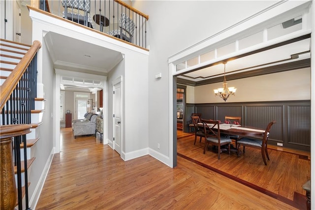 dining room featuring crown molding, hardwood / wood-style flooring, and a notable chandelier