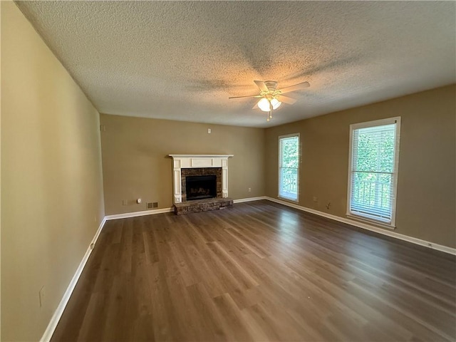 116 Cumberland Way, Dallas, GA 30132 - unfurnished living room featuring dark wood-type flooring, a ceiling fan, a textured ceiling, and a fireplace